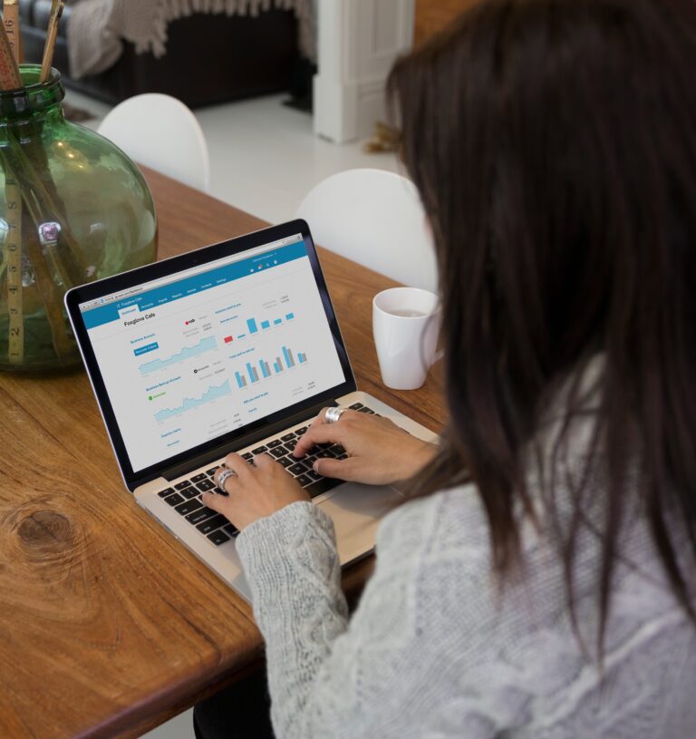 Professional working on a laptop displaying financial analytics graphs on Xero software, highlighting the convenience of cloud-based accounting solutions.